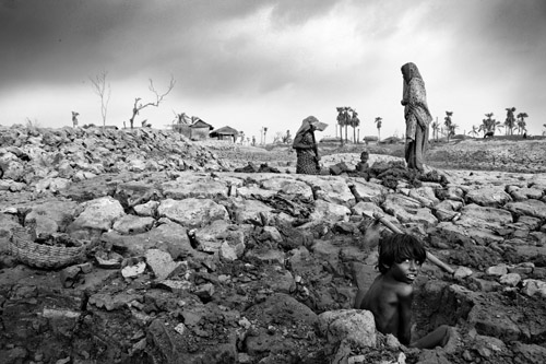 Climate change, and the increase in frequency and intensity of natural disasters, brings real consequences to the human: populations living in coastal communities.Mohammad Rakibul Hasan captures the desperation in his photograph featuring a young girl who is digging deep into soil saturated with salt water, hoping to find logs to burn as fuel. Two years after Cyclone Aila, the communities along Bangladesh’s southwest coastline are starting to rebuild their lives. Photograph by Mohammad Rakibul Hasan Courtesy of Marine Photobank